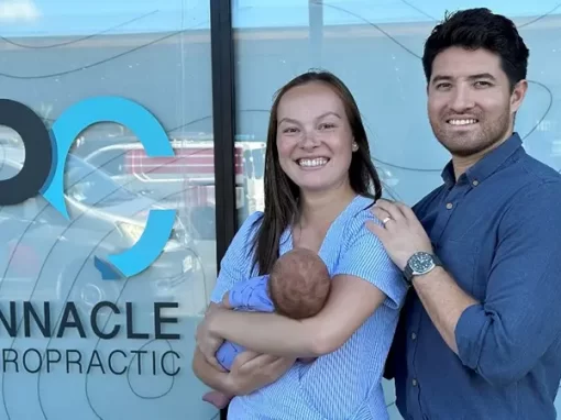 Family photo outside of Pinnacle Chiropractic celebrating the clinic being open for 1 year.